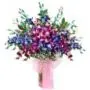 Celebrate With a beautiful mixture_of_ 15 lavender_and_blue_orchids_arranged_in_a_glass_vase looking_rich_and_beautiful