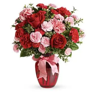 15 red roses with 10 pink carnations arranged in vase