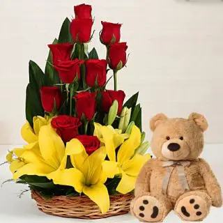 Basket arrangement of fresh lilies and roses with 2 feet height brown colour teddy bear