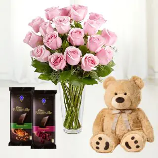 12 pink roses in glass vase with 6 inch brown teddy bear & 2 bournville chocolate