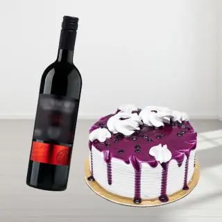 blueberry fresh cream cake with bottle of red wine