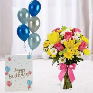 Beautiful mix flowers arrangement in glass vase ,mix color balloons with birthday card
