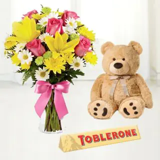  beautiful mix flowers vase arrangement with toblerone chocolate with 6 inch brown teddybear 