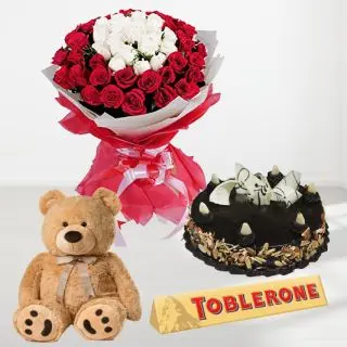 Bouquet of 50 red and white roses , chocolate almond cake , 1 feet height cute teddybear with toblerone chocolate 4300