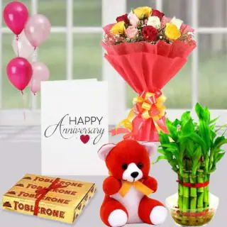 Bunch of 10 mix roses, set of 3 toblerone chocolates, 1 feet height teddybear ,2 layer Lucky bamboo plant ,5 blown balloons with anniversary greeting card