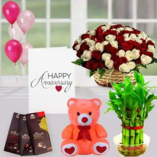 50 red and white roses basket , 6 inch teddybear, set of 3 bournville chocolates, 2 layer Lucky bamboo plant ,5 blown balloons with anniversary greeting card