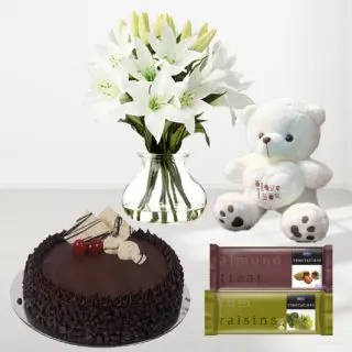 8 white lilies in glass vase with chocolate chips cake with 1 feet height white teddybear with pair of 2 temptations chocolate 