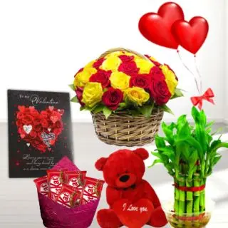 Basket of 15 red and yellow roses basket , 6 inch teddybear, basket of 20 kit kat chocolates,  2 layer Lucky bamboo plant ,5 blown balloons with greeting card 