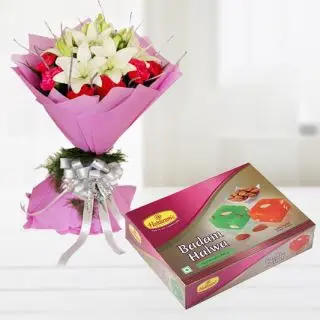 Bunch of white lilies with red carnationswith half kg badam halwa