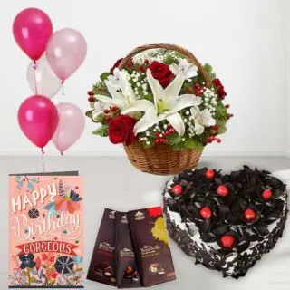 Basket of red roses and white lilies, heart shape black forest cake, set of 3 bournville chocolates, birthday greeting card, with 5 blown balloons