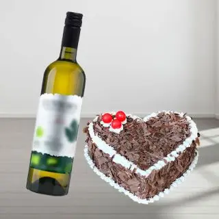 heart shape black forest fresh cream cake with bottle of  white wine