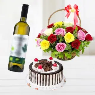 Beautiful basket of mix flowers with chocolate fantasy cake with bottle of white wine 