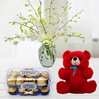  white orchids in glass vase with 6 inch red teddy bear & box of 16 pcs ferrero rocher chocolate 