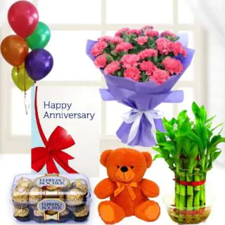 Bunch of 8 pink carnations, 6 inch teddybear, 16 pcs rocher ferrero chocolates, 2 layer Lucky bamboo plant ,5 blown balloons with anniversary greeting card