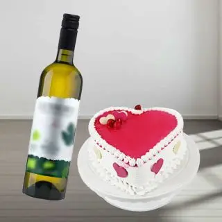 strawberry cake with bottle of white wine