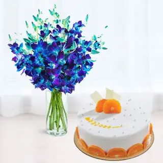 10 blue orchids arranged in glass vase with half kg orange cool cake 