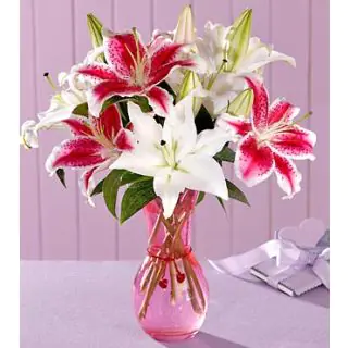10 Pink and white lilies in a glass vase