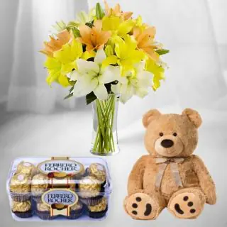  beautiful vase arrangement of lilies with 16 pcs ferrero rocher chocolate & cute 6 inch teddy bear