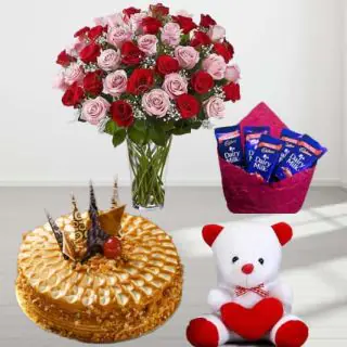 20 red and pink roses in glass vase , premium quality butterscotch cake , 6 inch teddybear with pack of 5 dairy milk chocolates 