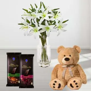 10 white lilies in glass vase with set of 2 bournville chocolates and 6 inch teddy bear