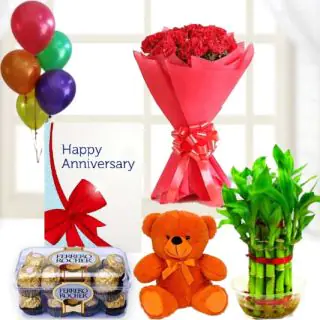 Bunch of 10 red carnations, 16 pcs rocher ferrero chocolates, 6 inch teddybear, 2 layer Lucky bamboo plant ,5 blown balloons with anniversary greeting card