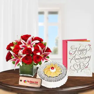 Vase arrangement of red and pink lilies with 1 kg pineapple cool cake with anniversary card 