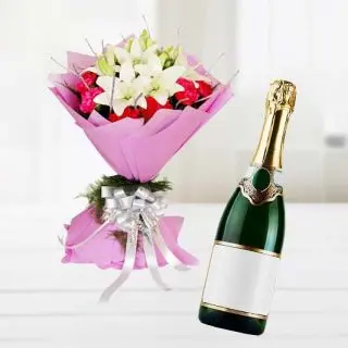 Bunch of lilies and carnations with bottle of champegne