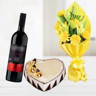 Bunch of gerberas & lilies with heart shape butterscotch cake with bottle of red wine