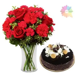 12 red roses with red carnations arranged in glass vase with 1 pound German chocolate cake 
