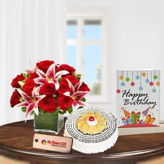 Vase arrangement of red and pink lilies with 1 kg pineapple cool cake with birthday card 