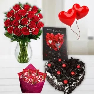 Vase arrangement of 15 red roses, 1 kg heart shape black forest cool cake, 2 heart shape balloons, greeting card, pack of 5 kit kat chocolates 