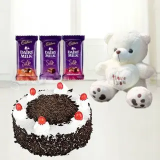 6 inch height white colour teddybear with 3 dairymilk silk chocolates with blackforest cake