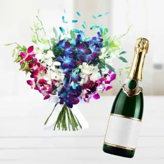 Bunch of lavender orchids with bottle of champege