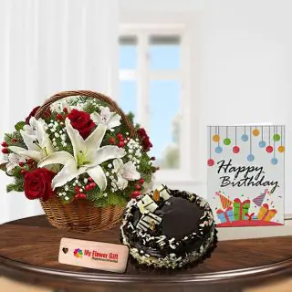 Beautiful Basket arrangement of fresh red roses with exotic white lilies, half kg chocolate almond cake with birthday card 