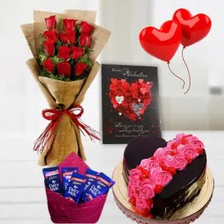 Bunch of 12 red roses, 1 kg heart shape chocolate cake with floral topping with 2 heart shape balloons,valentine card pack of 5 dairy milk chocolates 