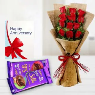 Bunch of 12 red roses in jute packing, set of 2 dairy milk silk chocolates, anniversary greeting card 