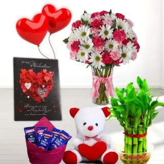 Mix flowers arranged in glass vase, Basket of 10 dairy milk chocolates, 6 inch height teddybear, 2 layer Lucky bamboo plant, 5 blown balloons with greeting card 