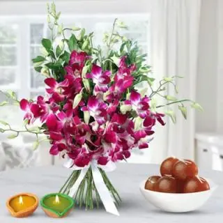 Orchids in glass vase with 1 kg gulab jamun 