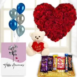 Heart shape arrangement of 30 red roses, 6 inch white teddybear, basket of assorted chocolates, anniversary  Greeting card with 5 mix blown balloons 