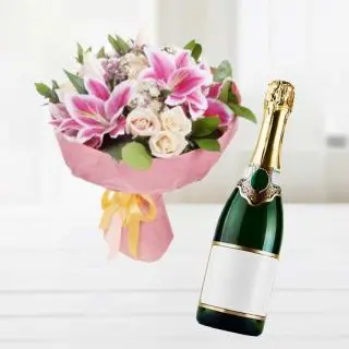 Bunch of white lilies with red roses with bottle of champegne
