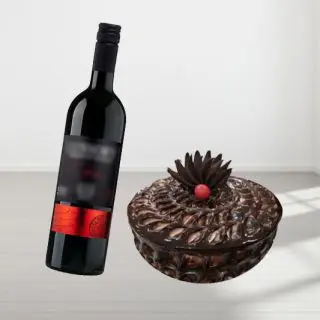 chocolate fantasy cake with bottle of red wine 