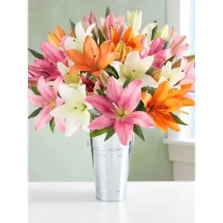 15 mix colour lilies beautifully  arranged in a glass vase 