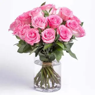 15 pink roses arranged in glass vase 