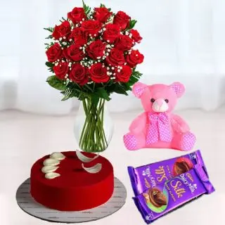 15 red roses in glass vase, red velvet cake, set of 2 dairy milk chocolates, 6 inch pink teddy bear 