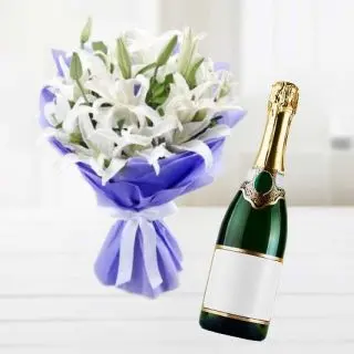 Bunch of white lilies with bottle of champegne 