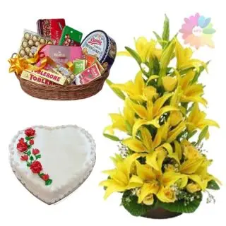 Exclusive arrangement of yellow lilies with 2.5 feet height with chocolate hamper of premium chocolates with vanilla heart shape cake 