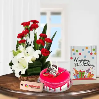 Basket Arrangement of red carnations with white lilies , Half kg strawberry cake with birthday greeting card 