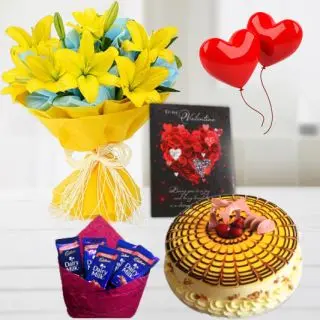 Bunch of 5 yellow exotic lilies, 1 kg heart shape butterscotch cake , pack of 5 dairy milk chocolates, Greeting card with 2 heart shape balloons 