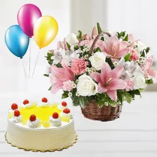 Basket of white lilies with pink roses with pineapple cake with 3 blown balloons
