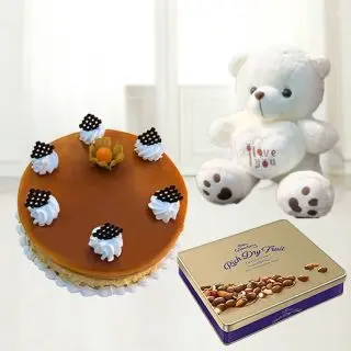  butterscotch cake with celebration buts chocolates with 6 inch white colour teddybear